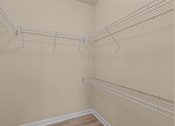 Empty shelves in a room with beige walls.