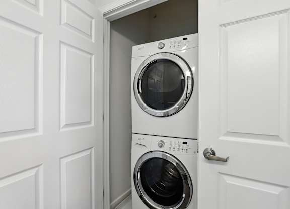 Two washing machines are stacked in a small space at Bramblett Hills Luxury Apartments in O Fallon MO 63366