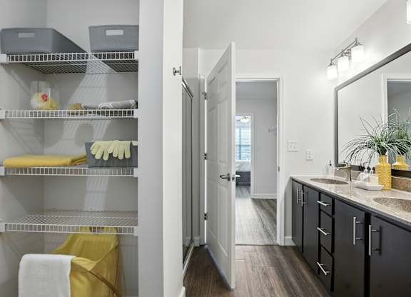 A bathroom with a mirror, sink, and towel at Bramblett Hills Luxury Apartments in O Fallon MO 63366