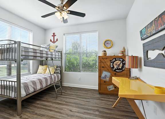 A room with a bunk bed and a desk at Bramblett Hills Luxury Apartments in O Fallon MO 63366