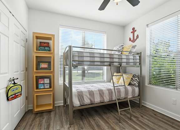 A room with a bunk bed and a bookshelf at Bramblett Hills Luxury Apartments in O Fallon MO 63366
