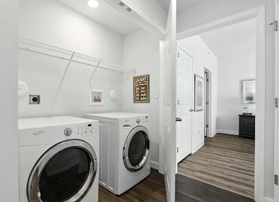 A laundry room with a washer and dryer at Bramblett Hills Luxury Apartments in O Fallon MO 63366