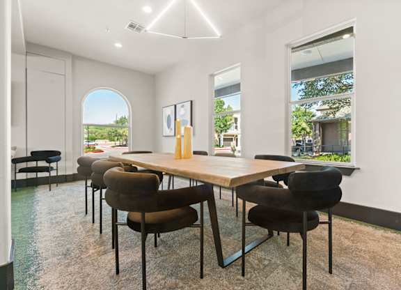 A conference room with a long table and chairs.