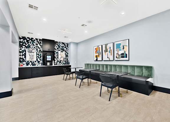 A room with a long bench and a table with chairs.