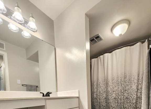 a bathroom with a shower and a sink and a toilet