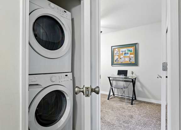 A white washing machine is in a doorway.
