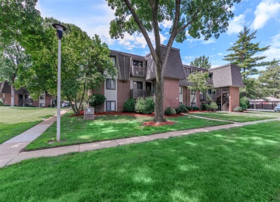 our apartments are located in a quiet neighborhood with green grass and trees
