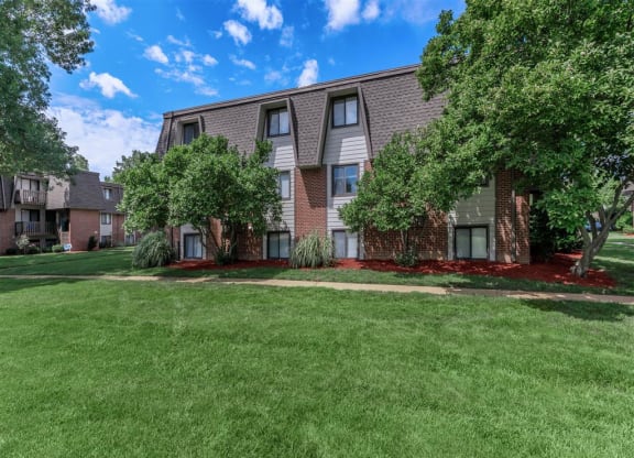 our apartments have a spacious yard with green grass and trees