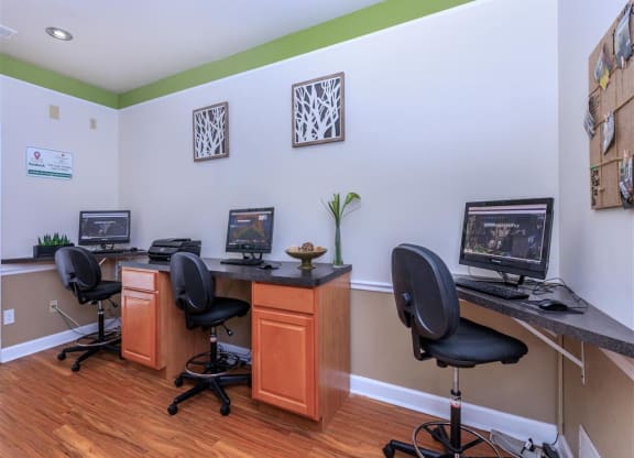 a home office with two desks and two computer monitors