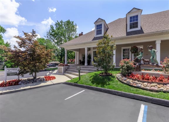 a house with a driveway and statues in front of it