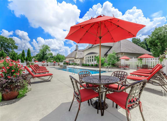 our apartments have a large patio with tables and chairs and a pool