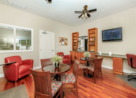 a living room and dining room with a table and chairs