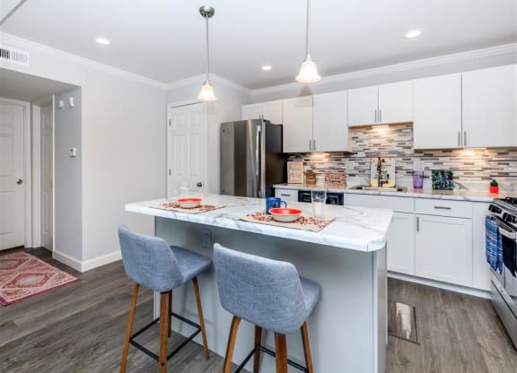 a kitchen with an island and two stools