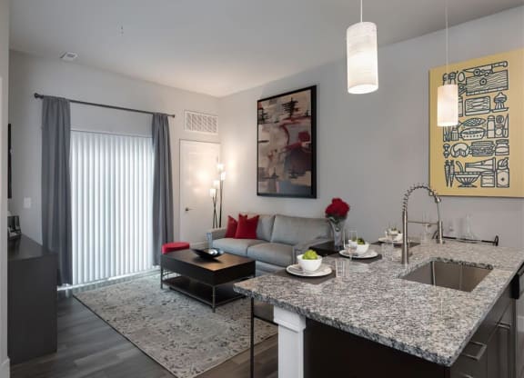 a kitchen and living room with a granite counter top
