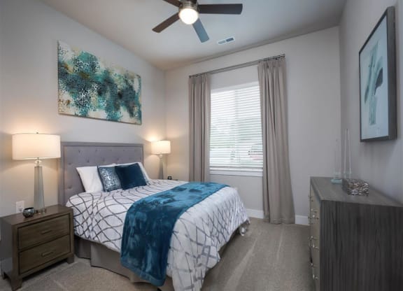 a bedroom with a bed and a ceiling fan