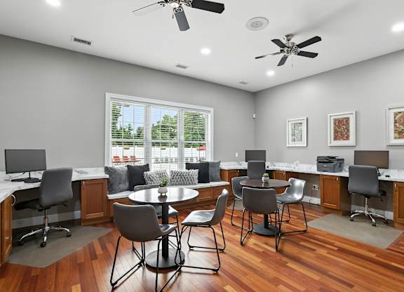 A modern office space with wooden floors and white walls.