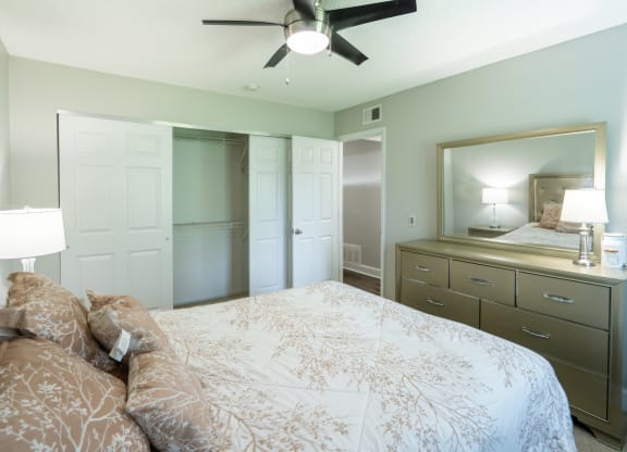 a bedroom with a large bed and a closet