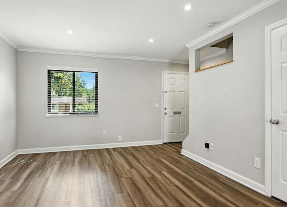 A room with wooden floors and white walls.