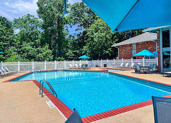 A large outdoor swimming pool with a red and white border.