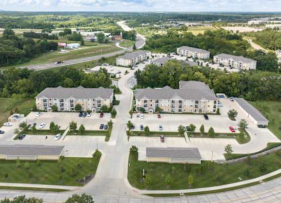 A large building complex with a parking lot in front.