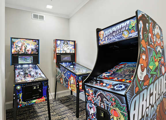 Two pinball machines are on display in a room.