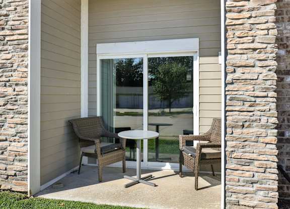 A patio with a table and chairs is shown.