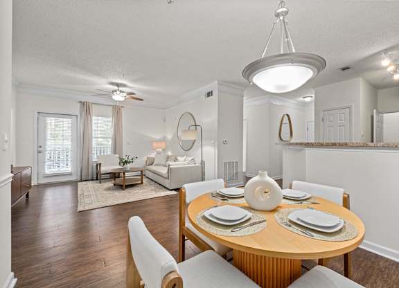 A dining room with a round table set for six.