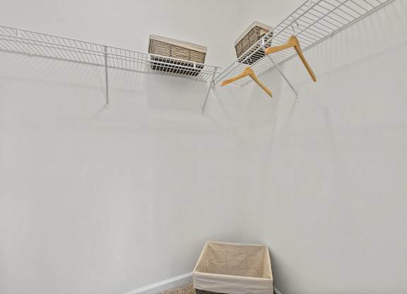 Two shelves with boxes on them are mounted on a wall.