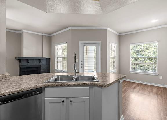 A kitchen with a sink and a window.