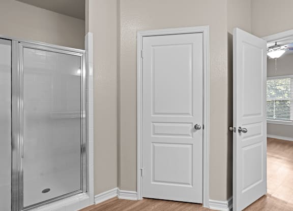 A white door is on the left of a white door and a white door is on the right.