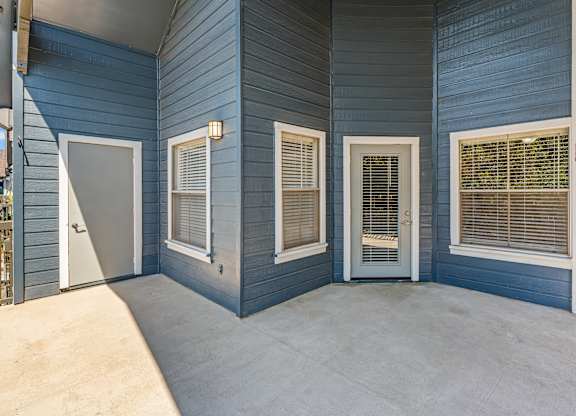 A blue house with white doors and windows.