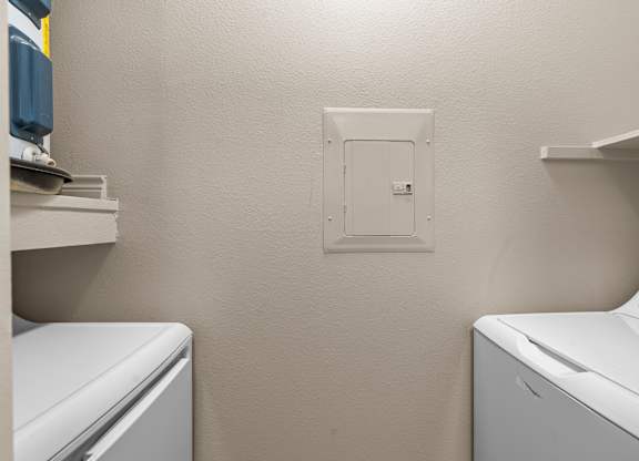 A white washing machine and dryer in a small laundry room.