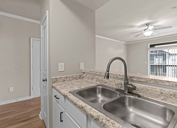 A kitchen with a sink and a window.