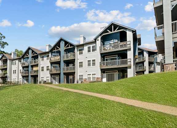 A large grassy area in front of apartment buildings.
