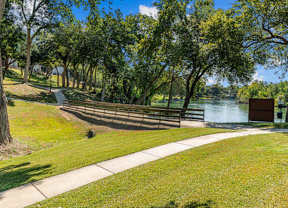 A park with a bench and a lamp post.