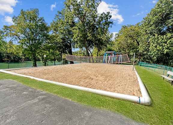 A playground with a sandbox and a slide.