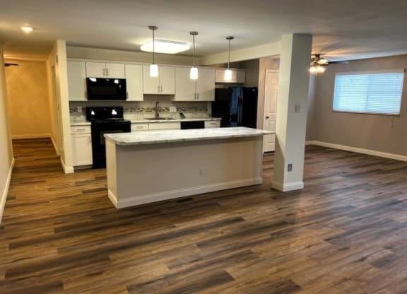 an empty kitchen with an island in the middle