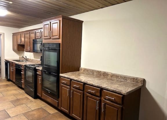 a kitchen with granite counter tops and a refrigerator
