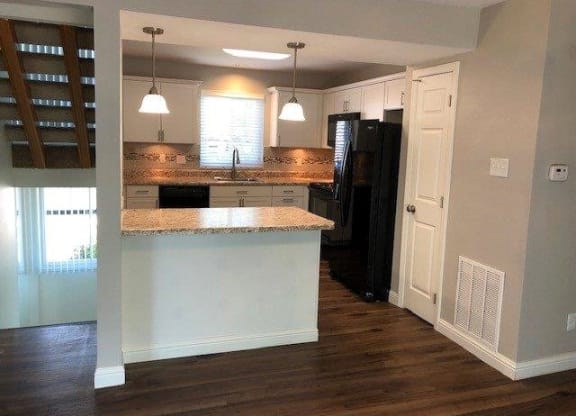a kitchen with an island in the middle of it