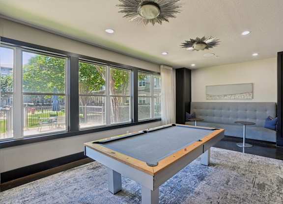 Recreation room with pool table and lounge seating at Highline Urban Lofts Apartments, Cypress, TX