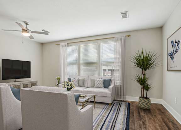 Living room with ceiling fan and large windows at Highline Urban Lofts Apartments, Texas, 77429