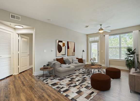 Open concept living room with modern furnishings and vaulted ceiling at Highline Urban Lofts Apartments, Cypress, Texas