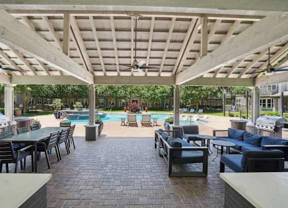 Covered outdoor pavilion with seating and pool views at Highline Urban Lofts Apartments, Cypress