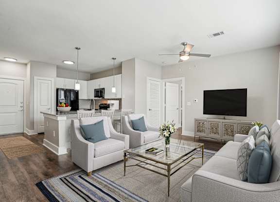 Open concept living area with kitchen and island seating at Highline Urban Lofts Apartments, Cypress, TX