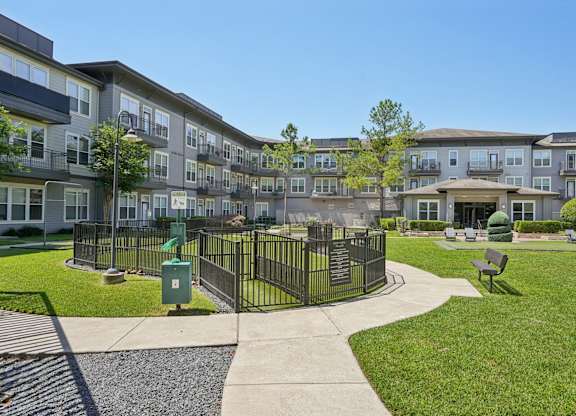 Fenced dog park with walking paths and courtyard at Highline Urban Lofts Apartments, Cypress, 77429