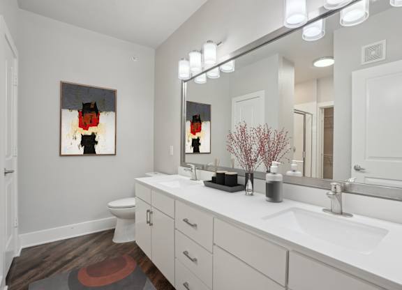 Dual vanity bathroom with white countertops and modern lighting at Highline Urban Lofts Apartments, Cypress, Texas