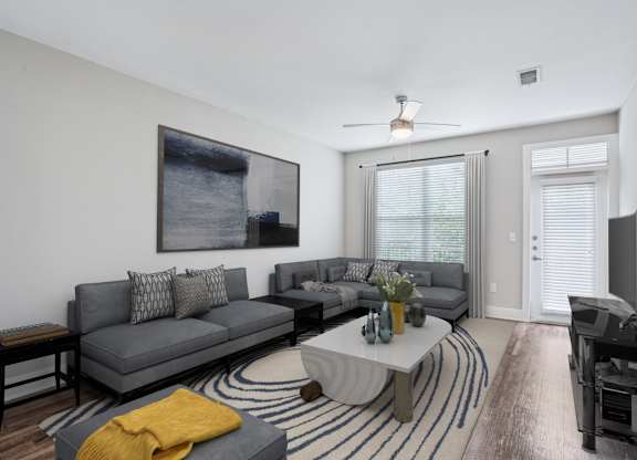 Modern living room with sectional sofa and abstract artwork at Highline Urban Lofts Apartments, Texas