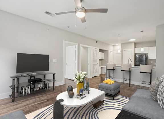 Open living room with kitchen island and bar seating at Highline Urban Lofts Apartments, Texas, 77429