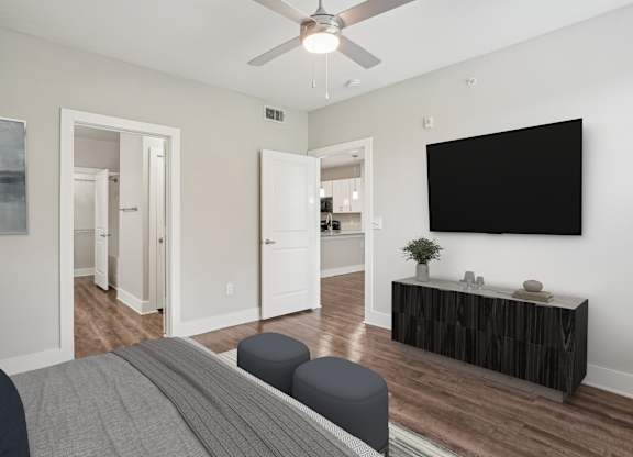 Bedroom with wall mounted tv and media console at Highline Urban Lofts Apartments, Texas
