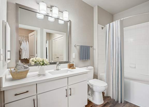 Bathroom with white vanity and tub shower combo at Highline Urban Lofts Apartments, Cypress, 77429